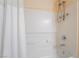 Clean white bathroom with a combined shower and tub with updated fixtures and shower curtain at 3088 Bicentennial Pkwy, Henderson, NV 89044