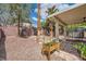 A partially covered backyard with gravel and a trampoline and small trees at 3257 River Glorious Ln, Las Vegas, NV 89135