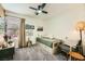 Charming bedroom with carpet, ceiling fan, natural light, and comfortable chair at 3257 River Glorious Ln, Las Vegas, NV 89135