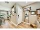 A welcoming entryway with wood-look flooring, decorative mirrors, and views into the kitchen and living areas at 3257 River Glorious Ln, Las Vegas, NV 89135