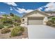 Charming single-story home with desert landscaping, well-maintained lawn, and a gray concrete driveway at 3257 River Glorious Ln, Las Vegas, NV 89135