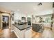 Charming kitchen featuring modern appliances, white cabinets, a kitchen island with seating, and sleek black countertops at 3257 River Glorious Ln, Las Vegas, NV 89135
