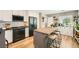 Modern kitchen featuring black appliances, an island with seating, and white cabinets at 3257 River Glorious Ln, Las Vegas, NV 89135