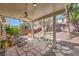 Covered patio area with stone flooring and outdoor seating at 3257 River Glorious Ln, Las Vegas, NV 89135