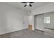 Bedroom with ceiling fan, neutral carpet, closet and view into dining area at 3318 N Decatur Blvd # 1043, Las Vegas, NV 89130
