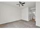Spacious bedroom with ceiling fan, neutral carpet, and access to bathroom at 3318 N Decatur Blvd # 1043, Las Vegas, NV 89130