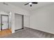 Bedroom with ceiling fan, neutral carpet, sliding mirror closet, and stacked washer/dryer at 3318 N Decatur Blvd # 1043, Las Vegas, NV 89130