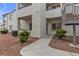 Beige two story condo with staircase, walkway and desert landscaping at 3318 N Decatur Blvd # 1043, Las Vegas, NV 89130