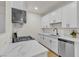 Updated kitchen with white cabinetry, stone counters and stainless appliances at 3318 N Decatur Blvd # 1043, Las Vegas, NV 89130
