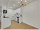 Bright kitchen with all-white cabinets, stainless steel appliances and modern light fixture at 3318 N Decatur Blvd # 1043, Las Vegas, NV 89130