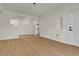 Living room with light wood floors and access to dining area and laundry at 3318 N Decatur Blvd # 1043, Las Vegas, NV 89130