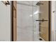 Modern shower featuring marble tile, black hardware, and glass door at 3318 N Decatur Blvd # 1043, Las Vegas, NV 89130