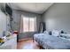 Bedroom with gray walls, tile flooring, and a window that lets in natural light at 3432 Beca Faith Dr, North Las Vegas, NV 89032