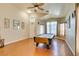 A spacious game room features an elegant pool table, ceiling fan, and gleaming wood floors at 3432 Beca Faith Dr, North Las Vegas, NV 89032