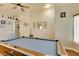 A spacious game room features an elegant pool table, ceiling fan, and gleaming wood floors at 3432 Beca Faith Dr, North Las Vegas, NV 89032
