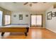 A spacious game room features an elegant pool table, ceiling fan, and gleaming wood floors at 3432 Beca Faith Dr, North Las Vegas, NV 89032