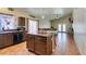 Well-lit kitchen featuring tile flooring, wood cabinets, stainless steel appliances, and a center island with seating at 3432 Beca Faith Dr, North Las Vegas, NV 89032