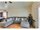 Comfortable living room featuring a large sectional sofa with throw pillows and a view of the backyard at 3432 Beca Faith Dr, North Las Vegas, NV 89032