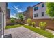 Backyard featuring pavers, artificial grass and small trees/bushes providing a charming outdoor area at 345 Gracious Way, Henderson, NV 89011