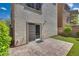 Paver patio leading to a sliding glass door and the landscaped backyard featuring artificial grass at 345 Gracious Way, Henderson, NV 89011