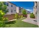 Serene backyard featuring artificial grass, paver patio, block wall, and small trees/bushes at 345 Gracious Way, Henderson, NV 89011