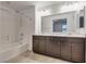 Bathroom featuring double sink vanity with framed mirror, and a bathtub with shower at 345 Gracious Way, Henderson, NV 89011