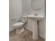 Clean half bathroom features a pedestal sink, toilet, and tile flooring at 345 Gracious Way, Henderson, NV 89011