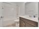 Clean bathroom featuring a shower-tub combo, tile flooring, and a dark wood vanity at 345 Gracious Way, Henderson, NV 89011