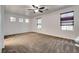 Spacious bedroom features plush carpeting, ample natural light from windows, and modern ceiling fan at 345 Gracious Way, Henderson, NV 89011