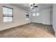 Large bedroom features soft carpet, bright light from windows and a ceiling fan at 345 Gracious Way, Henderson, NV 89011