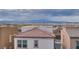 Elevated view of neighborhood with tile rooftops under a cloudy sky, mountains on the horizon at 345 Gracious Way, Henderson, NV 89011