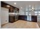 Open kitchen boasts stainless appliances and granite countertops, seamlessly connecting to living spaces at 345 Gracious Way, Henderson, NV 89011
