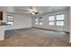 Expansive living room with neutral carpet, ceiling fan, and multiple windows at 345 Gracious Way, Henderson, NV 89011