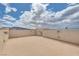Expansive rooftop deck area with tan stucco walls and city views in the distance at 345 Gracious Way, Henderson, NV 89011