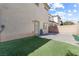 Backyard showcasing patio, turf and privacy fence at 3532 Carisbrook Dr, North Las Vegas, NV 89081