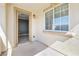 Cozy covered balcony features neutral stucco walls, views of the neighborhood, and an open doorway at 3532 Carisbrook Dr, North Las Vegas, NV 89081