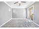 Bedroom featuring gray carpet, gray walls, crown molding, and sliding glass doors to the outside at 3532 Carisbrook Dr, North Las Vegas, NV 89081