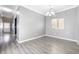 Bright dining room featuring gray wood floors, chandelier lighting, and a large window at 3532 Carisbrook Dr, North Las Vegas, NV 89081