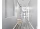 Long hallway with gray wood flooring, neutral walls, and recessed lighting at 3532 Carisbrook Dr, North Las Vegas, NV 89081