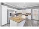 Bright kitchen with stainless steel appliances, granite island, white cabinets, and modern design at 3532 Carisbrook Dr, North Las Vegas, NV 89081