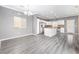 Open-concept kitchen with stainless steel appliances, white cabinetry, and granite countertops at 3532 Carisbrook Dr, North Las Vegas, NV 89081