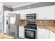 Stylish kitchen with stainless steel appliances, granite countertops, and white cabinetry at 3532 Carisbrook Dr, North Las Vegas, NV 89081