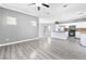 Open-concept living space features an adjacent kitchen with modern flooring and plenty of natural light at 3532 Carisbrook Dr, North Las Vegas, NV 89081