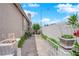 Landscaped side yard with gravel path, stone pavers, and potted plants offering a serene outdoor space at 3592 N Campbell Rd, Las Vegas, NV 89129