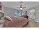 Bright bedroom featuring a ceiling fan, outside view, and ensuite bathroom access at 3592 N Campbell Rd, Las Vegas, NV 89129