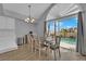 Bright dining area with a chandelier, large windows, and sliding glass doors to pool at 3592 N Campbell Rd, Las Vegas, NV 89129