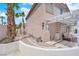 A charming home exterior featuring a desert landscape with decorative palms and an open pergola patio area at 3592 N Campbell Rd, Las Vegas, NV 89129