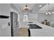 Bright kitchen features a large island with a cooktop and stainless steel appliances at 3592 N Campbell Rd, Las Vegas, NV 89129