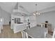 Bright kitchen with white cabinets, stainless steel appliances, and dining area at 3592 N Campbell Rd, Las Vegas, NV 89129