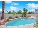 Backyard pool surrounded by lush landscaping, rock features, and a white fence, offering a tranquil oasis at 3592 N Campbell Rd, Las Vegas, NV 89129